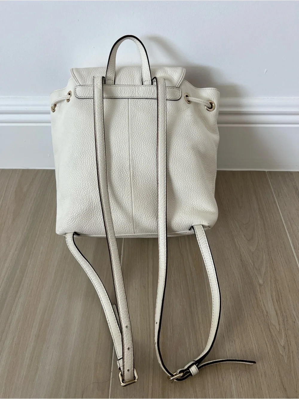 Kate Spade New York creamy white leather drawstring flap backpack